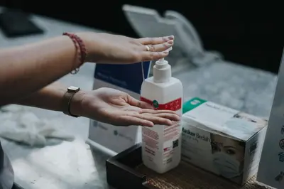 a person is holding a bottle of bleach at The Capital Hotel and Resort Seminyak in Seminyak