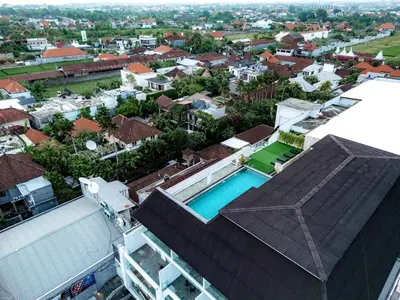 an overhead view of a building with a swimming pool at The Capital Hotel and Resort Seminyak in Seminyak