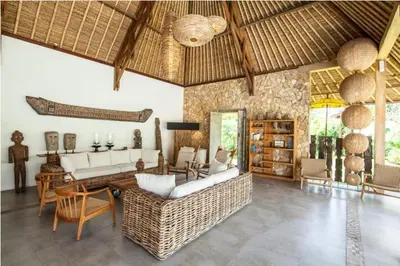 a living room with a couch and a table at Villa Katapappa in Seminyak