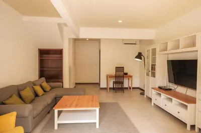 a living room with a couch and a table at UMA LIMA VILLA - 7Min Beach Access - 10min to Canggu in Canggu