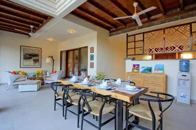 a dining room with a long table and chairs at UMA LIMA VILLA - 7Min Beach Access - 10min to Canggu in Canggu