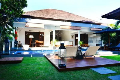 a villa with a swimming pool and a house at Premium Villas Seminyak I in Seminyak