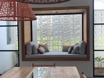 a window seat in a room with a view of a building at Villa MOSAIC - Stunning Designed Spacious Villa - Center Canggu in Canggu