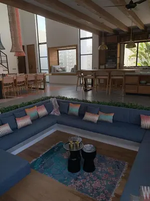 a living room with a blue couch and a table at Villa MOSAIC - Stunning Designed Spacious Villa - Center Canggu in Canggu