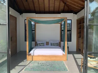a bedroom with a bed with a canopy at Villa MOSAIC - Stunning Designed Spacious Villa - Center Canggu in Canggu