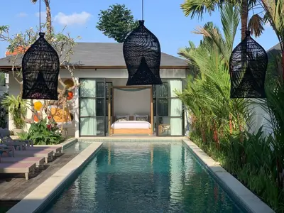 a villa with a swimming pool and a bedroom at Villa MOSAIC - Stunning Designed Spacious Villa - Center Canggu in Canggu