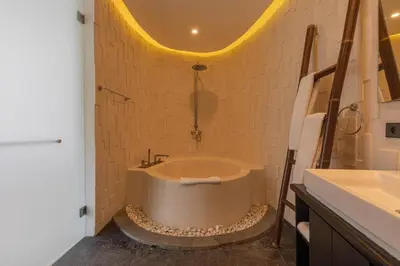 a bathroom with a tub and a sink at Taman Mesari Luxury Villas-Seminyak in Seminyak