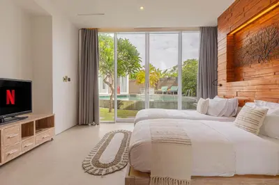 a large bedroom with a large bed and a tv at Taman Mesari Luxury Villas-Seminyak in Seminyak