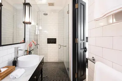 a white bathroom with a tub and a sink at Villa Nago Walk to Seminyak Best Spots in Seminyak