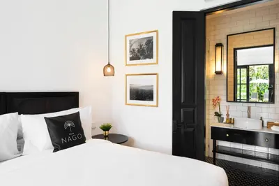 a bedroom with a white bed and a sink at Villa Nago Walk to Seminyak Best Spots in Seminyak
