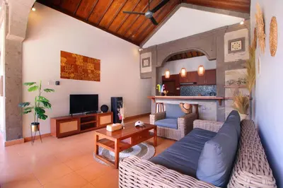 a living room with a couch and a table at Sudha Villa Bali B in Seminyak