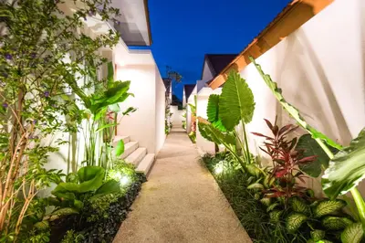 a garden with a walkway with plants and lights at Taman Sari Pengubengan Villa in Kerobokan