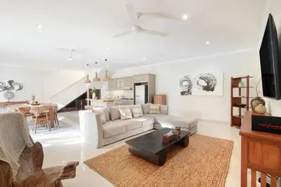 a living room with a white couch and a table at Villa Maleena in Seminyak