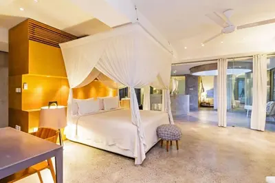 a bedroom with a white bed with a canopy at Villa C99 Seminyak in Kerobokan