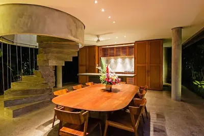 a dining room with a wooden table and chairs at Villa C99 Seminyak in Kerobokan