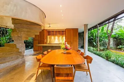 a dining room with a wooden table and chairs at Villa C99 Seminyak in Kerobokan