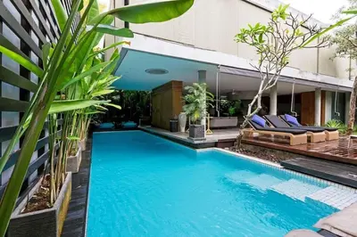 a swimming pool in the middle of a building with plants at Villa C99 Seminyak in Kerobokan