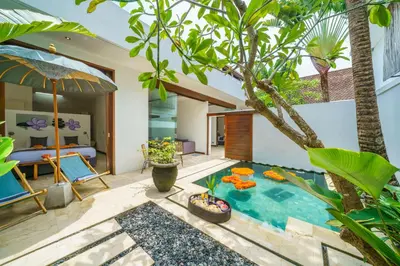 a pool in the middle of a backyard with a bedroom at Anema Villa Seminyak in Legian