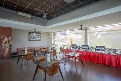 a restaurant with tables and chairs in a room at Asa Bali Luxury Villas & Spa in Seminyak