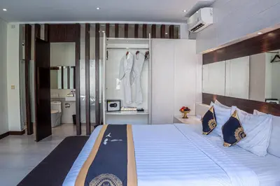 a bedroom with a large bed and a bathroom at Asa Bali Luxury Villas & Spa in Seminyak