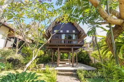 a tree house in the middle of a garden at Casa Jimbaran Villa in Jimbaran