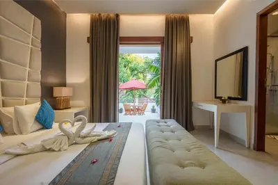 a hotel room with a bed and a desk with swans on it at Villa Orange 3BR Seminyak by Exotic Bali Properties in Seminyak