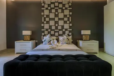 a bedroom with a large bed with two night stands at Villa Orange 3BR Seminyak by Exotic Bali Properties in Seminyak