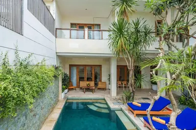 a villa with a swimming pool and a house at Villa Orange 3BR Seminyak by Exotic Bali Properties in Seminyak