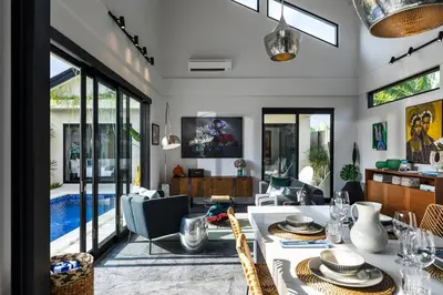 a living room with a table and chairs at Summer House Villa in Canggu