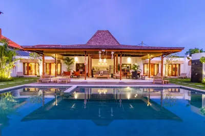 a villa with a swimming pool at night at Villa Hana by Alfred in Bali in Seminyak