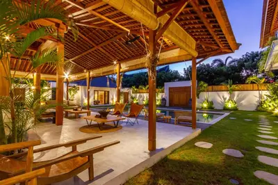 an outdoor patio with a wooden pergola at Villa Hana by Alfred in Bali in Seminyak