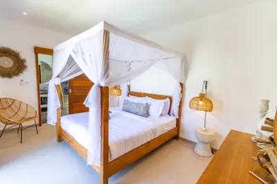 a bedroom with a canopy bed in a room at Villa Hana by Alfred in Bali in Seminyak