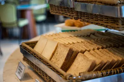 a tray of bread sitting on top of a table at Grand Livio Kuta Hotel in Legian