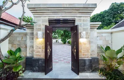 an entrance to a house with an open door at KELAN-TEL BALI in Jimbaran