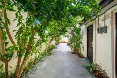 a hallway with trees on the side of a building at KELAN-TEL BALI in Jimbaran