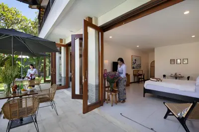 a woman standing in the living room of a villa at Huge 11 BR Villa, Sleeps 41, Prime Area, Near Beach in Canggu