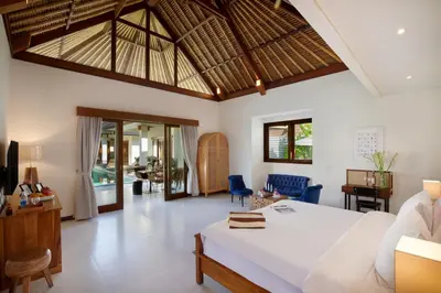 a bedroom with a bed and a living room at Huge 11 BR Villa, Sleeps 41, Prime Area, Near Beach in Canggu