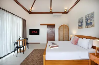 a bedroom with a large white bed and a desk at Huge 11 BR Villa, Sleeps 41, Prime Area, Near Beach in Canggu