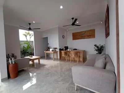 a living room with a couch and a table at The Awandari Villas Seminyak in Seminyak