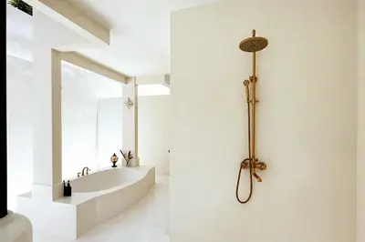 a bathroom with a bath tub and a sink at Villa de Malicott in Seminyak