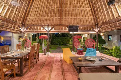 a restaurant with tables and chairs and a large roof at Luxury Villa La plancha BEACH 200m, Heart of Seminyak in Seminyak