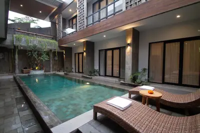a swimming pool in the middle of a building at D Home Seminyak in Seminyak