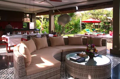 a living room with a couch and a glass table at Imani Villas in Canggu