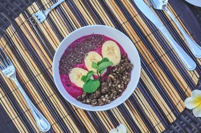 a bowl of food with fruit and nuts on a table at Villa Litera Seminyak Bali in Seminyak