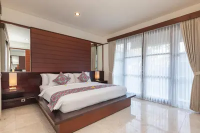 a bedroom with a large bed and a large window at Villa Litera Seminyak Bali in Seminyak