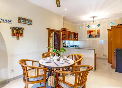 a kitchen and dining room with a table and chairs at Villa Retro 88 in Seminyak