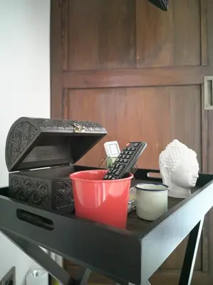 a table with a remote control and other items on it at Villa Brabhan Seminyak in Seminyak
