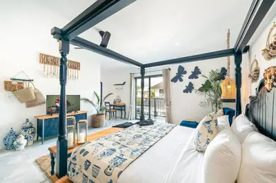 a bedroom with a blue and white bed in a room at Luxe 5 Bed, Sleeps 10, Butler, Walk to ShopsCafe in Seminyak