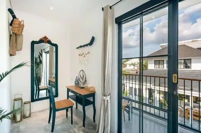 a room with a mirror and a desk and a window at Luxe 5 Bed, Sleeps 10, Butler, Walk to ShopsCafe in Seminyak