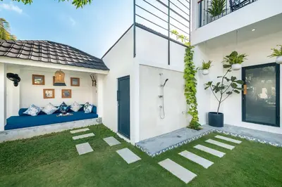 a house with a blue bed in a yard at Luxe 5 Bed, Sleeps 10, Butler, Walk to ShopsCafe in Seminyak
